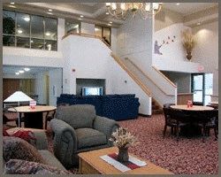 a living room filled with furniture and a staircase